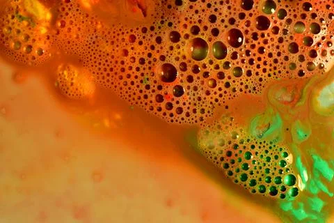 Texture pattern of soap bubbles on a brown and green background. Stock Photos
