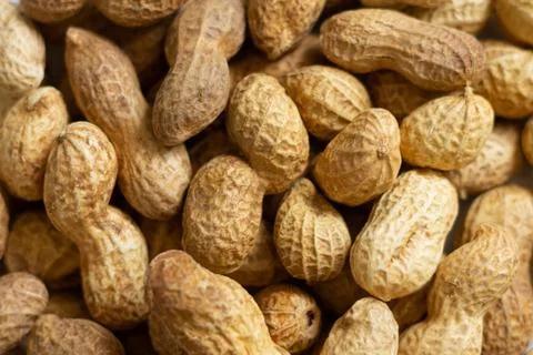 Texture of peanuts in shell and organic groundnuts background Stock Photos