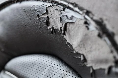Texture of peeling black leather office chair, closeup Stock Photos