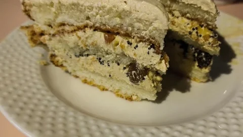 Texture of a piece of cake with cream in a plate close-up. Chocolate cake with Stock Footage 324782007