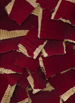 Texture from pieces of torn colored cardboard. Red brown carton background Stock Photos
