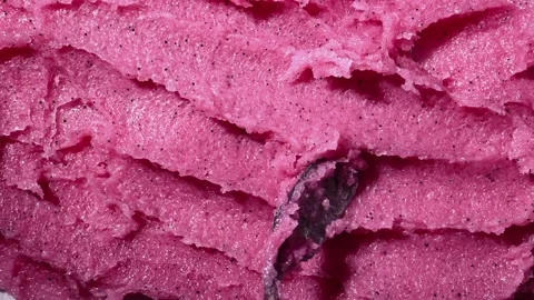Texture of pink strawberry scrub. Fruit exfoliation scrubber for body. Stock Footage 311024004