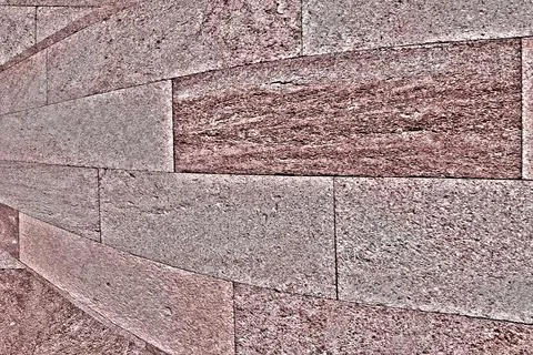 Texture of pinkish stone. The surface is rough and porous. Solid sandstone stone 스톡 사진