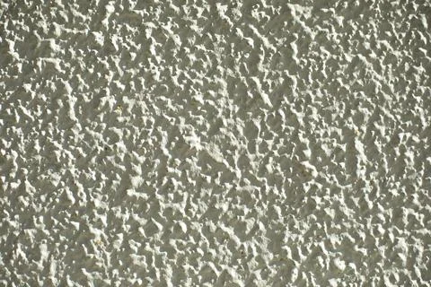 Texture of plaster on wall. Stone wall is white. Small stone. Stock Photos