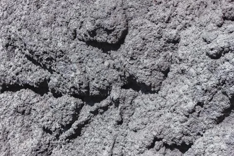 The texture of the plastered wall. Rough corrugated cement surface. Uneven pa Stock Photos