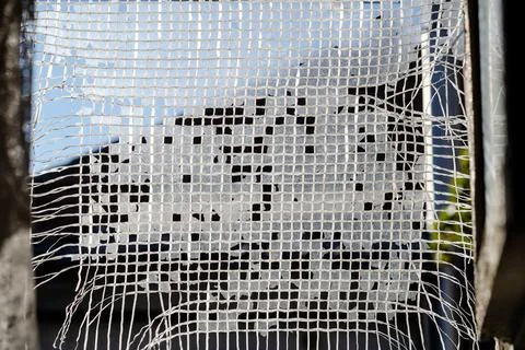 Texture of plastic mesh. Squares of white threads. Selective focus. Abstract  Stock Photos