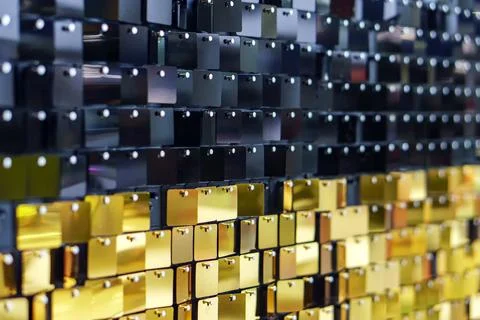 Texture plastic squares of black and gold color with multi-colored highlights Stock Photos