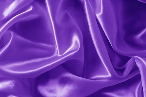 The texture of the proton purple cloth with waves and shrugs. Shiny fabric. Stock Photos