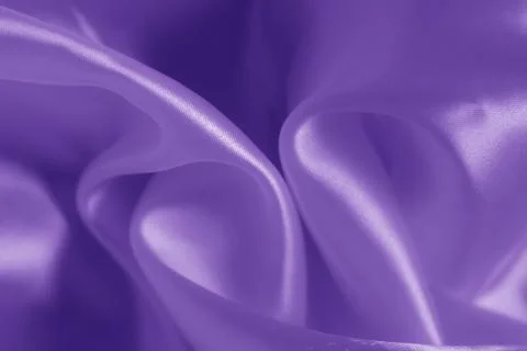 The texture of the proton purple cloth with waves and shrugs. Shiny fabric. Stock Photos