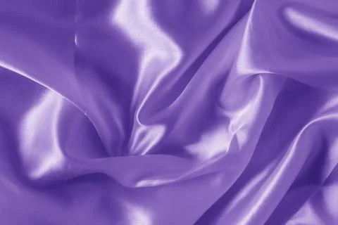The texture of the proton purple cloth with waves and shrugs. Shiny fabric. Stock Photos