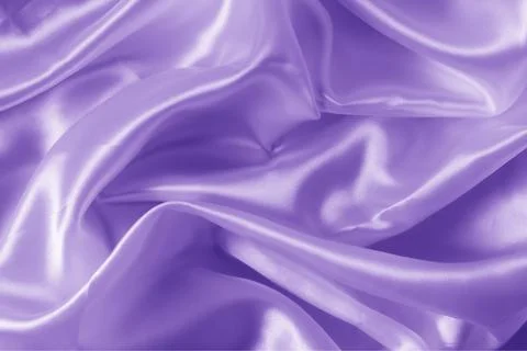The texture of the proton purple cloth with waves and shrugs. Shiny fabric. Stock Photos