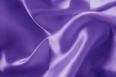 The texture of the proton purple cloth with waves and shrugs. Shiny fabric. Stock Photos