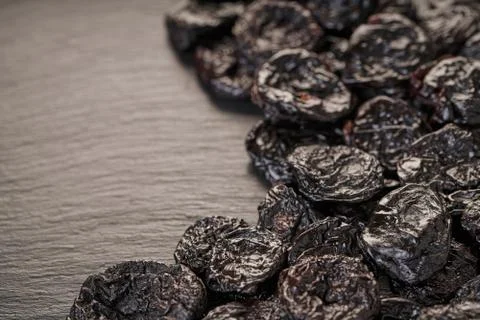 Texture of prunes close-up on black Stock Photos