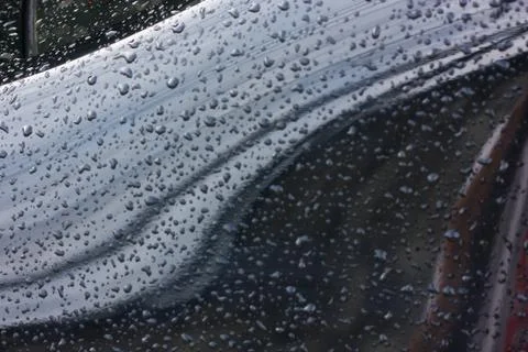 Texture of rain drops on window with reflections Stock Photos
