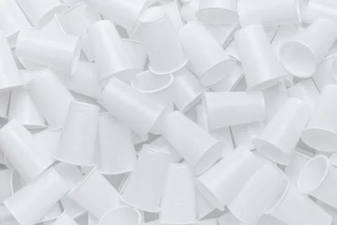 The texture of randomly scattered white disposable plastic cups. Abstract bac Stock Photos