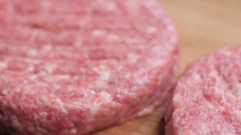 The texture of a raw burger patty. Production of fast food. Stock Footage 228648919