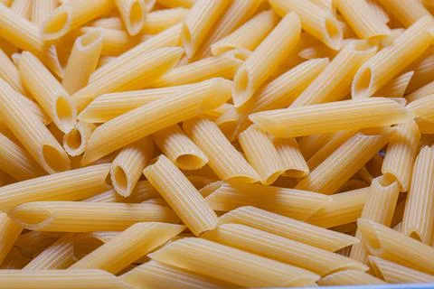 Texture of raw pasta feathers top view Stock Photos