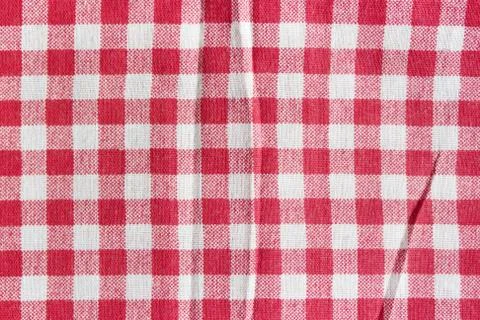 Texture of a red and white checkered picnic blanket. Red linen crumpled table Stock Photos