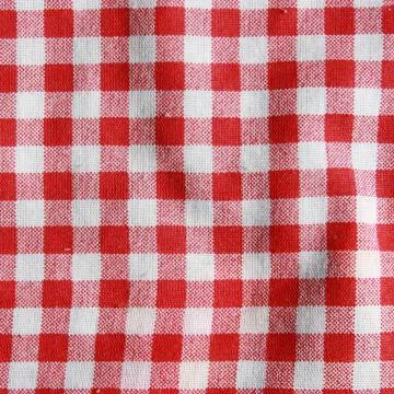 Texture of a red and white checkered picnic blanket. Red linen crumpled table Stock Photos