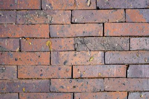 Texture. Red brick brick wall with spots of different shapes Foto stock