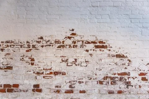 The texture of red brick masonry with fallen off whitewash. Stock Photos