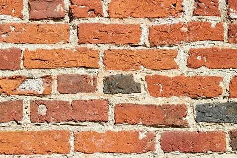 Texture of a red brick wall. Wall of an ancient building made of red burnt brick Stock Photos