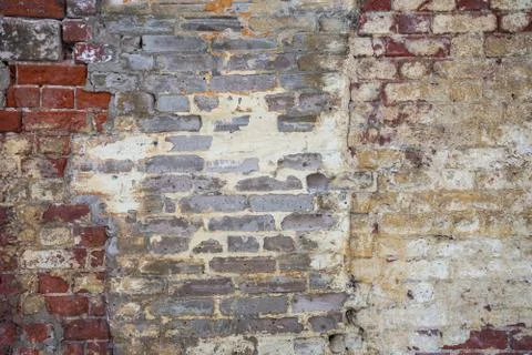 Texture of red brickwork with peeled white paint Stock Photos