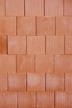 Texture of red ceramic building blocks stacked together. Modern clay hollow bric Stock Photos