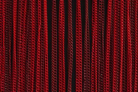 Texture of a red chain on a black background Stock Photos