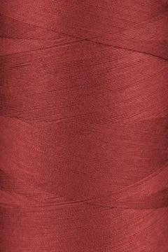 Texture of red color threads in spool close up, macro Stock Photos