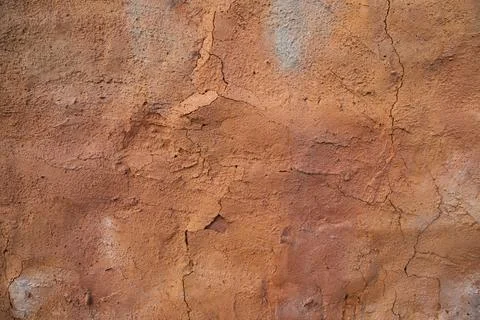 The texture of a red concrete wall with cracks and scratches can be used as a Stock Photos