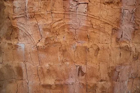 The texture of a red concrete wall with cracks and scratches can be used as a Stock Photos