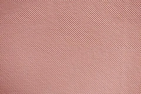 Texture of red fabric with a repeating uniform pattern of dots 写真素材