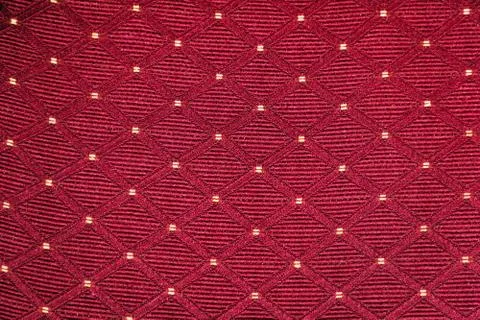 Texture of red fabric with rombic pattern with white dot Stock Photos