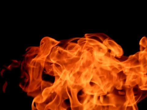 Texture of red fire flame on a black background Stock Photos