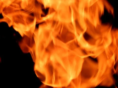 Texture of red fire flame on a black background Stock Photos