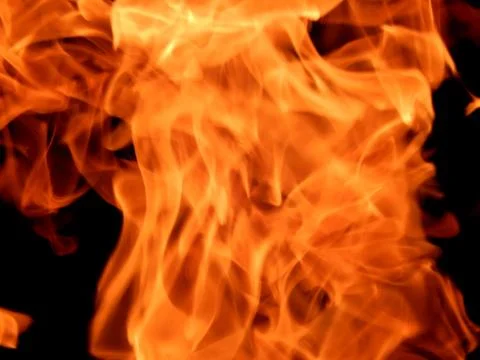 Texture of red fire flame on a black background Stock Photos