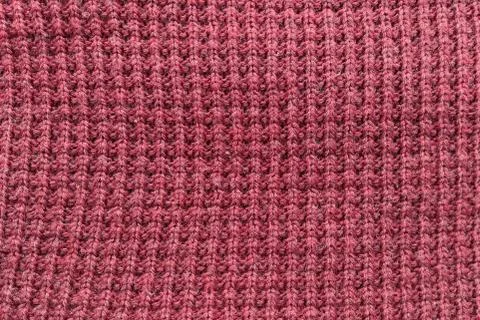 Texture of red knitted fabric close up. Wool knitwear. Winter autumn sweater Stock Photos