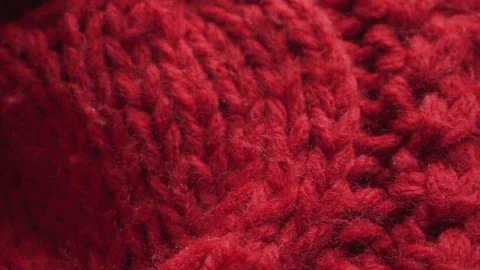 Texture of a red knitted scarf. Closeup shot, slow motion. Stock Footage 98357024
