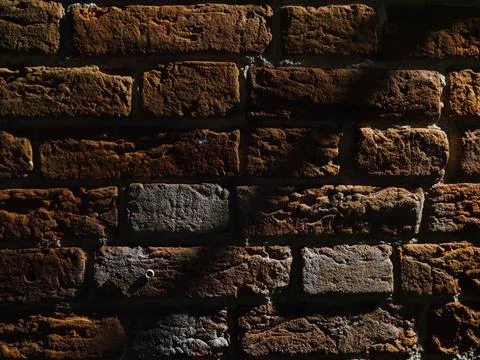 The texture of the red old brick wall is almost completely dark Stock Photos
