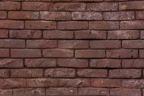 The texture of a red painted brick wall. Grunge background. Brick surface. Cl Stock Photos