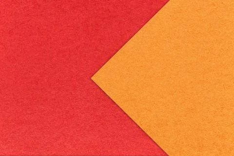 Texture of red paper background, half two colors with orange arrow, macro. Stockfoto's