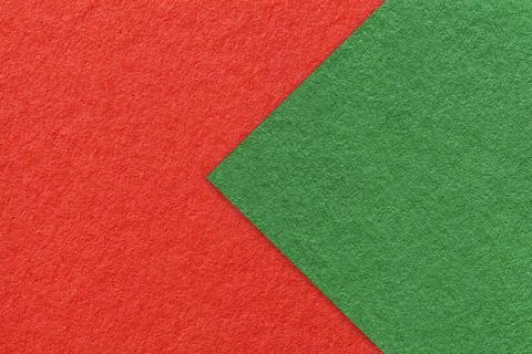 Texture of red paper background, half two colors with green arrow, macro. Stockfoto's