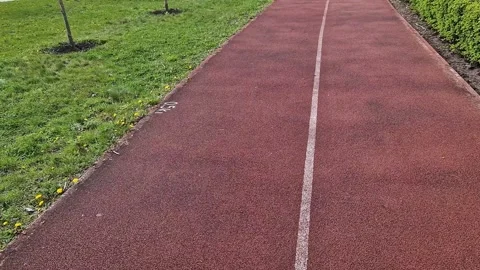 Texture of red running or cycling surface in a park Stock Footage 333451758