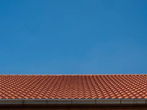 Texture of red tile rooftop on blue sky background Stock Photos