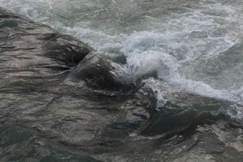 Texture river creek stream. Fast flowing water in the mountain river Stock Photos