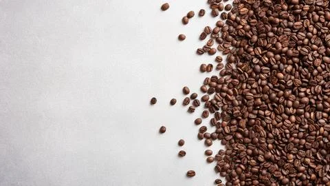 Texture of roasted coffee beans on gray concrete background Stock Photos