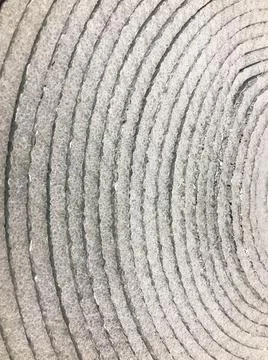 Texture from a roll of round beautiful gray silvery shiny foil for heat insul Fotos Stock