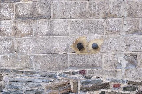 Texture of rough masonry grey rough bricks and cement between them, stone wall Stock Photos