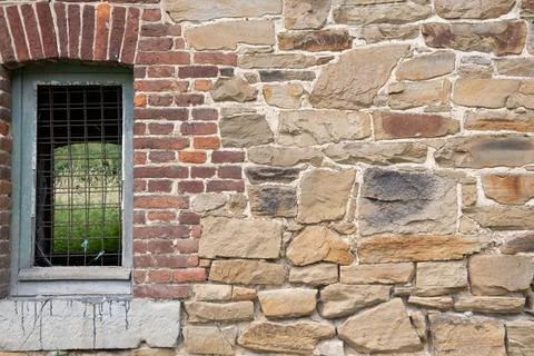 Texture of rough masonry yellow rough bricks and cement between them, stone wall Stock Photos